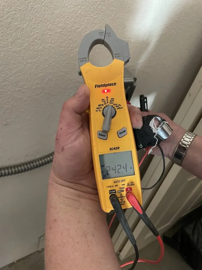 Voltage testing with clamp meter during Electrical Installation Services in Harlingen